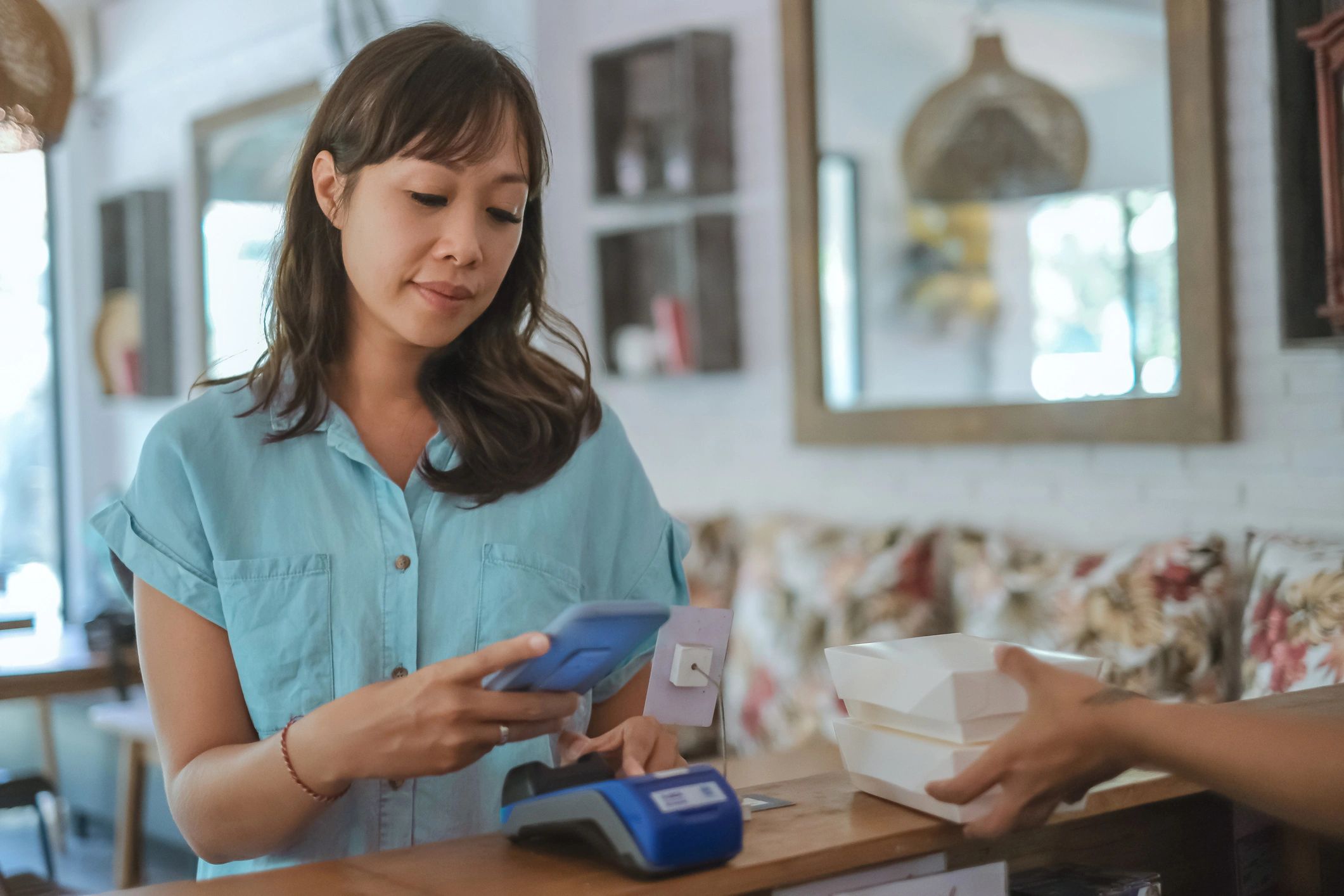 Customer scanning a QR code to pay for a takeout order