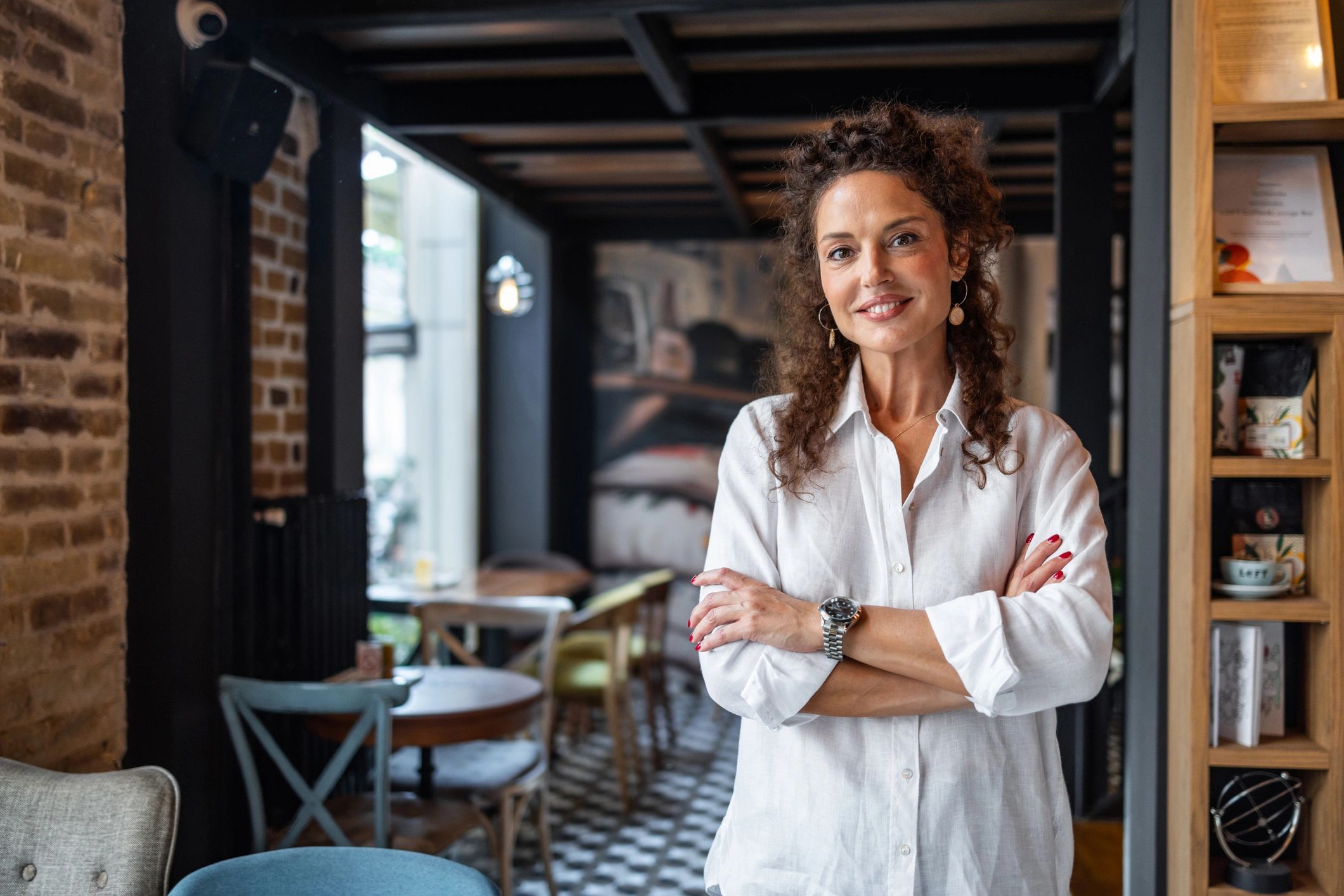 Restaurant owner smiling inside the dining room