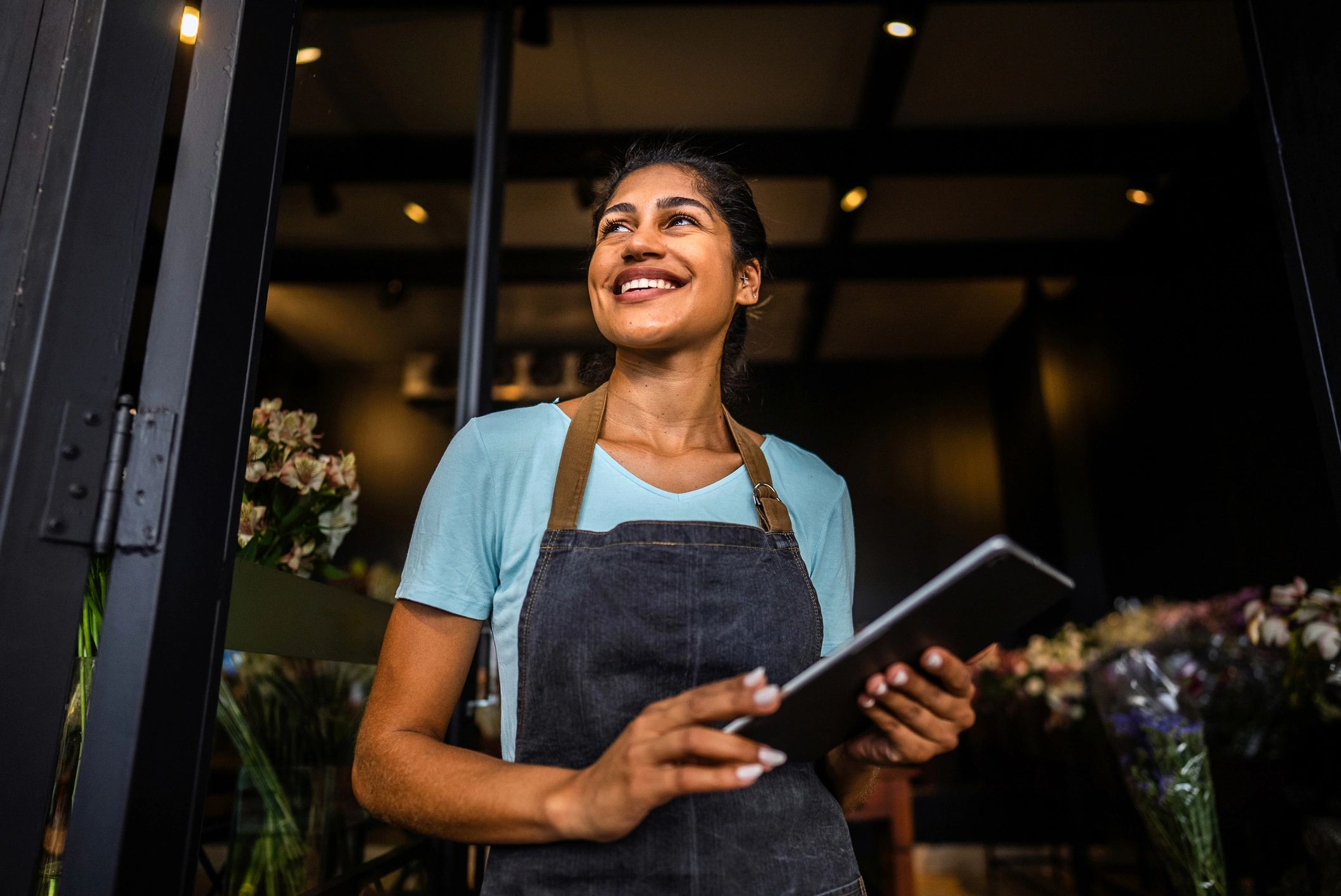 Restaurant owner smiling behind the counter