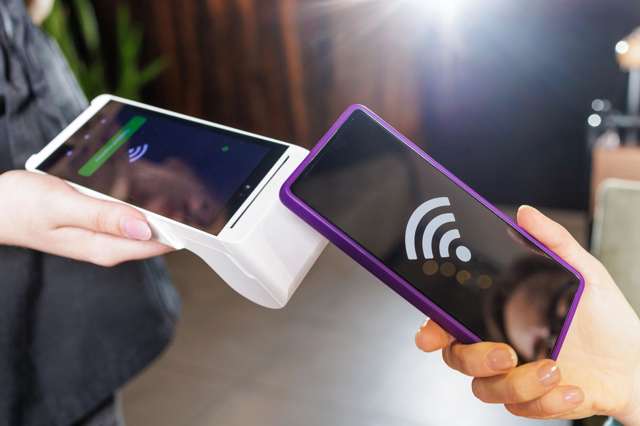 Customer using a smartphone to scan and earn a loyalty stamp at checkout